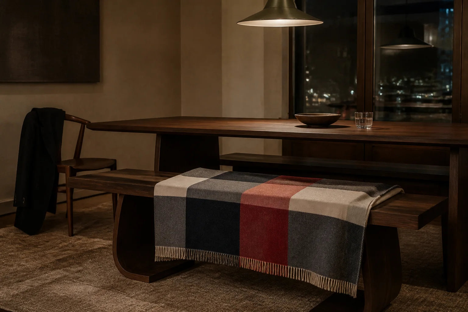 Checked Sofia Toscano throw on a dark wooden bench