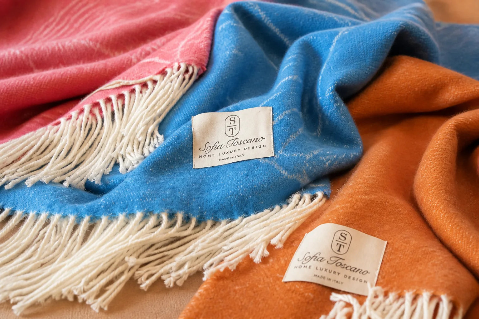 Sofia Toscano throws in blue, coral and orange with woven motifs and pale fringes